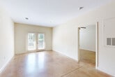 Located at 4375 Regency Dr in High Point, NC, this one-bedroom unit offers a thoughtfully laid-out single-floor plan with a clean, modern aesthetic throughout. Polished stained concrete floors extend seamlessly across every room, lending the space an industrial-chic character that is both durable and visually striking.

The open-concept kitchen and living area serves as the heart of the unit. The kitchen is well-appointed with warm maple cabinetry, granite countertops, stainless steel appliances including a refrigerator, dishwasher, and range, and a bold stainless steel wall-mounted range hood. Track lighting overhead ensures excellent task illumination. The living area flows naturally from the kitchen and is anchored by a set of French doors that invite natural light and provide outdoor access.

The bedroom is a comfortable and well-proportioned retreat, featuring a ceiling fan, a bright window with outdoor views, and neutral walls that create a calm atmosphere. An adjacent walk-in closet offers generous wire shelving for ample storage.

The bathroom is neatly finished with a granite-topped vanity with wood cabinetry, a full soaking tub with shower, built-in shelving, and a large mirror with overhead lighting. Consistent concrete flooring ties the bathroom seamlessly to the rest of the unit.