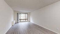 Located in the heart of Washington, DC, Unit 326 at 1225 L St NW is a well-organized one-bedroom, one-bathroom residence offering a clean, modern aesthetic throughout. The open living room serves as the centerpiece of the unit, featuring light gray wood-style flooring, crisp white walls, and a large picture window that frames views of the surrounding cityscape and fills the room with natural light. Track lighting complements the bright, airy atmosphere of the space.

The bedroom is a comfortable, well-proportioned room with the same consistent flooring, neutral walls, and a sliding-door closet, providing practical storage. In total, the unit includes three closets, offering generous storage options throughout.

The kitchen is efficiently laid out with warm wood cabinetry, granite-style countertops, and white appliances including a refrigerator, dishwasher, and built-in microwave. The bathroom features a full tub-shower combination with white tile surround, mosaic tile flooring, and clean, simple finishes.

Throughout the unit, the consistent use of light tones and updated flooring creates a cohesive, modern feel. The unit's location in Washington, DC's vibrant downtown corridor provides convenient access to dining, transit, and cultural attractions.
