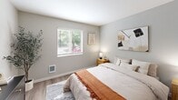 Located at 3811 NE Third Ct in Renton, Washington, this one-bedroom, one-bathroom unit offers a well-organized single-floor layout designed to maximize every square foot of its compact footprint. The interior features a consistent wood-style plank flooring and a neutral gray-toned color palette throughout, lending the space a cohesive, modern aesthetic.

The galley-style kitchen is thoughtfully designed with white shaker cabinetry lining both walls, light quartz countertops, a stainless steel refrigerator, black electric range, and a dishwasher. Ample upper and lower cabinet storage makes the kitchen highly functional despite its streamlined footprint.

The bedroom is a well-proportioned retreat, featuring a window that admits natural light and offers a view of surrounding greenery. A built-in sliding-door closet provides convenient storage, while the room comfortably accommodates standard bedroom furniture.

The bathroom includes a full-sized soaking tub and shower combination with clean white surround panels, brushed nickel fixtures, and wood-style flooring that ties back to the rest of the unit.

A connecting hallway links the rooms efficiently, contributing to the unit's practical flow. Overall, the space presents a clean, move-in-ready environment suited for those seeking a low-maintenance, modern living space in the Renton area.
