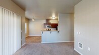 Located at 3517 Hill St SE in Albany, Oregon, this two-bedroom, two-bathroom single-floor residence offers a practical and comfortable layout designed for everyday living. The open-concept living area features warm, neutral-toned walls and plush carpeting that extends through the main living space and bedrooms, creating a cohesive and inviting atmosphere. A peninsula-style kitchen seamlessly connects to the living area and is equipped with rich dark-toned cabinetry, stainless steel appliances including a refrigerator, microwave, and range, as well as tile flooring and ample counter space. A dedicated dining nook adjacent to the kitchen features large windows that draw in natural light and offer pleasant outdoor views. Both bedrooms are generously proportioned with soft carpet, neutral walls, and windows providing natural light. The primary bedroom includes closet space with built-in shelving for organized storage. A dedicated laundry area houses a full-size side-by-side washer and dryer, adding significant convenience. The two bathrooms complete the well-rounded layout. Clean lines, consistent finishes, and a thoughtful floor plan make this residence a highly functional and comfortable home.