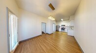 Located at 430 E Elm St in Springfield, MO, this modern 1-bedroom, 2-bathroom unit offers a thoughtfully designed single-floor layout. Light wood-style flooring flows throughout the main living areas, creating a clean and cohesive aesthetic.

The open-concept living and dining area is bright and welcoming, featuring a stylish pendant light fixture and a glazed entry door with sidelight that fills the space with natural light and urban views. The kitchen is well-appointed with white shaker cabinetry extending to the ceiling, stone-look countertops, a deep single-basin sink, and a full suite of stainless steel appliances including a refrigerator, electric range, over-the-range microwave, and dishwasher.

The bedroom features plush carpet flooring, high ceilings, and corner windows that bring in generous natural light. A dedicated closet with built-in shelving and hanging rods provides organized storage. The hallway, which also houses an electrical panel, connects the main living areas to the private spaces.

Both bathrooms are finished with wood-look tile flooring, white vanities with stone-look countertops, and full bathtub-shower combinations. A dedicated laundry area adds everyday convenience, rounding out this well-equipped and efficiently designed urban residence.