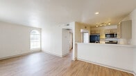 Located at 1540 Chenault St in Dallas, TX, this single-story 2-bedroom, 1-bathroom home offers a clean, modern aesthetic with a cohesive design throughout. Warm wood-look flooring runs continuously across all living areas, complementing the crisp white walls and creating a bright, welcoming atmosphere.

The living room serves as the heart of the home, featuring a ceiling fan, an elegant arched window, and a sliding glass door that invites generous natural light and outdoor views. The front entry door includes frosted glass sidelights, adding both style and additional light to the space.

The galley-style kitchen is efficiently laid out, featuring gray shaker cabinetry, light marble-style countertops, a stainless steel sink, a dishwasher, and a full suite of appliances including a refrigerator, all illuminated by track lighting overhead.

Both bedrooms are well-proportioned and outfitted with ceiling fans and ample natural light from large windows. The primary bedroom includes a dedicated closet with built-in shelving, while the second bedroom features a sliding closet. A hallway connects the sleeping areas to the shared full bathroom, which includes a tiled tub-shower combination and wood-look flooring.

A closet provides additional storage, rounding out this efficiently designed and move-in ready home.