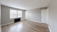 Located at 415 E 222nd St in Euclid, Ohio, this single-floor, 3-bedroom, 1-bathroom home offers a functional and well-maintained layout across a compact but efficiently organized footprint. Consistent wood-look luxury vinyl flooring flows throughout every room, complemented by neutral gray walls and crisp white trim that create a clean, cohesive aesthetic.

The spacious primary bedroom features dual windows that flood the room with natural light, a ceiling fan with light fixture, and a cast iron radiator — a classic heating element found throughout the home. The two additional bedrooms are equally well-appointed, each with ceiling fans and access to the connecting hallway.

The kitchen stands out as a clear highlight, featuring white shaker-style cabinetry, a white subway tile backsplash, stainless steel gas range, and a full-size refrigerator. A window above the sink brings in additional natural light, and a cast iron radiator adds character alongside modern finishes.

The bathroom is finished with full white tile surrounds, a soaking tub with shower, a white vanity, and a medicine cabinet mirror, all accented by a bright vanity light bar and a natural light-admitting window.

The living area provides generous open space with window views and a cast iron radiator, making the home practical, bright, and full of charm.
