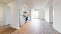 Located at 3030–3060 Pharmacy Ave in Toronto, this well-designed 3-bedroom, 2-bathroom unit offers a bright and functional single-floor layout. The open-concept living and dining area is flooded with natural light through large floor-to-ceiling windows, creating an airy and spacious feel. Wide-plank hardwood-style flooring runs consistently throughout the main living areas and bedrooms, lending a cohesive, modern aesthetic.

The kitchen is thoughtfully appointed with white cabinetry, stainless steel appliances including a refrigerator and range, a tile backsplash, and track lighting overhead. It flows seamlessly into the expansive living area, making it ideal for everyday living and entertaining.

The primary bedroom is generously sized and features a double-door closet and access to the hallway. The two additional bedrooms are bright and well-proportioned, with one benefiting from large windows that frame views of the surrounding neighbourhood. All bedrooms feature the same warm hardwood-style flooring.

Both bathrooms are finished with clean, neutral tile work, white vanities with undermount sinks, chrome fixtures, and tiled walk-in showers. The hallway connects all rooms efficiently, enhancing the unit's practical flow. Overall, the space presents a clean, contemporary finish throughout.