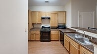Located at 342 Walden Station Dr in Charlotte, NC, this single-floor unit offers three bedrooms and three full bathrooms within a well-organized and functional layout. The open-concept living and dining area serves as the heart of the home, featuring warm hardwood-style flooring, a ceiling fan, and a private exterior door that brings in natural light. A wall-mounted TV and comfortable seating make the living space ideal for relaxing or entertaining. The dining area accommodates a full-sized table, seamlessly connecting to the kitchen. The kitchen is well-appointed with light maple cabinetry, dark granite-style countertops, black appliances including a range, dishwasher, and microwave, plus a double sink — providing ample functionality for everyday cooking. Each of the three bedrooms offers hardwood-style flooring, neutral warm-toned walls, and windows with natural views, creating a calm and comfortable atmosphere. The bedrooms are versatile, accommodating both sleeping and study needs. The three full bathrooms each feature a clean white tub-shower combo with brushed nickel fixtures and tile flooring, maintaining a consistent, practical aesthetic throughout. The unit's neutral color palette and cohesive design provide a move-in-ready foundation.