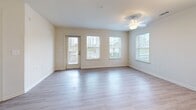 Located at 2945 Brick Church Pike in Nashville, TN, this one-bedroom, one-bathroom unit offers a well-organized, efficient layout across a single floor. The open-concept living and dining area greets you upon entry, featuring light-toned luxury vinyl plank flooring, neutral cream walls, and multiple windows that fill the space with natural light. A ceiling fan adds comfort, while a private exterior door provides convenient outdoor access with views of the landscaped community grounds.

The kitchen flows directly from the living area and is outfitted with rich dark wood cabinetry, light stone-finish countertops, a stainless steel sink, and black appliances including a refrigerator, range, and over-the-range microwave. Pendant lighting over the counter adds a modern touch.

The bedroom offers plush carpeting, a private door leading to an outdoor patio or balcony, and a dedicated window for natural light. A generously sized walk-in closet features built-in shelving and hanging rods, providing excellent storage and organization.

The bathroom includes wood-toned cabinetry, a single vanity with a white basin, and light vinyl plank flooring. Outside, the property features manicured lawns, mature trees, decorative stone landscaping, and open views of the surrounding Nashville area.