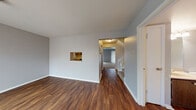 Located at 2000 McKelvey Hill Dr in Maryland Heights, Missouri, this multi-level residence spans three floors and offers a well-organized layout with a clean, neutral aesthetic throughout. The main living areas feature rich, dark hardwood-style flooring that contrasts attractively with light gray walls and white trim, creating a modern yet inviting atmosphere. A pass-through window connects the living area to the kitchen, adding an open, communicative feel between spaces. The kitchen is efficiently designed with a galley-style layout, offering ample cabinetry in warm wood tones, light countertops, a built-in dishwasher, and a black range with overhead ventilation. A sliding glass door and multiple windows in the living area allow for generous natural light and outdoor views. The upper levels transition to plush carpeting in the bedrooms, each of which features large windows with blinds for privacy and light control. Bathrooms are functional and well-appointed, with one featuring a full tub-shower combination and updated fixtures, and another with a vanity sink and mirrored medicine cabinet. The overall ambiance of the home is clean, bright, and move-in ready, with consistent finishes across all three floors that lend a cohesive and practical living environment.