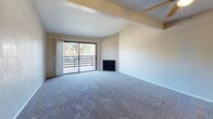 Located at 1540 Mosaic Way in Stockton, California, this two-bedroom, one-bathroom residence offers a well-organized single-level layout with a comfortable and functional design throughout. The living room serves as the heart of the home, featuring vaulted ceilings, a ceiling fan, a corner fireplace, and a sliding glass door that opens to a private balcony with outdoor views — filling the space with natural light. A pass-through window connects the living area to the galley-style kitchen, which is outfitted with white cabinetry, stone-look countertops, and white appliances including a refrigerator, electric range, and dishwasher, all set on light wood-look flooring. The primary bedroom is generously sized, complete with a ceiling fan, a large sliding-door closet, and a window that brings in natural light. A dedicated walk-in closet offers additional storage with built-in shelving and hanging rods. The second bedroom is carpeted and well-proportioned with its own closet access. The bathroom features light wood-look flooring, a vanity with ample storage, and a high clerestory window for natural light. Soft carpeting runs throughout the main living and bedroom areas, lending a warm and comfortable ambiance to the entire home.