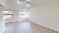Located in Miami, FL, this well-appointed 1-bedroom, 1-bathroom unit offers a thoughtfully designed layout that maximizes comfort and functionality. The open-plan living and dining area is immediately inviting, featuring light wood-style flooring, vaulted ceilings with track lighting, and a textured ceiling finish. Multiple windows bathe the space in natural light, creating a bright and airy atmosphere throughout.

The kitchen runs adjacent to the living area and is separated by a convenient breakfast bar with stone-look countertops. It is equipped with stainless steel appliances, a dishwasher, a deep single-basin sink, and warm wood-toned cabinetry with modern hardware — offering both style and practicality.

The bedroom is generously sized, featuring plush wall-to-wall carpeting, a textured ceiling, and a sliding glass door that opens to a private outdoor area, allowing for natural light and fresh air. A dedicated closet provides ample storage.

The bathroom is clean and functional, showcasing light wood cabinetry with a stone-look countertop, a full-size soaking tub with shower, and light wood-style flooring that ties the space together cohesively. Neutral, warm tones throughout the unit create a calm and versatile backdrop ready to accommodate a variety of personal styles.
