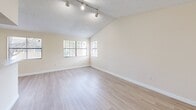 Located in Miami, FL, this well-appointed 1-bedroom, 1-bathroom unit offers a thoughtfully designed layout that maximizes comfort and functionality. The open-plan living and dining area is immediately inviting, featuring light wood-style flooring, vaulted ceilings with track lighting, and a textured ceiling finish. Multiple windows bathe the space in natural light, creating a bright and airy atmosphere throughout.

The kitchen runs adjacent to the living area and is separated by a convenient breakfast bar with stone-look countertops. It is equipped with stainless steel appliances, a dishwasher, a deep single-basin sink, and warm wood-toned cabinetry with modern hardware — offering both style and practicality.

The bedroom is generously sized, featuring plush wall-to-wall carpeting, a textured ceiling, and a sliding glass door that opens to a private outdoor area, allowing for natural light and fresh air. A dedicated closet provides ample storage.

The bathroom is clean and functional, showcasing light wood cabinetry with a stone-look countertop, a full-size soaking tub with shower, and light wood-style flooring that ties the space together cohesively. Neutral, warm tones throughout the unit create a calm and versatile backdrop ready to accommodate a variety of personal styles.