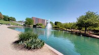 Situated at 434 Canal Court in Indianapolis, Indiana, this single-story space enjoys a prime position along the iconic Indianapolis Central Canal. The outdoor environment is a defining feature of this property, offering sweeping views of the tranquil canal waters, highlighted by a striking central fountain that serves as a visual focal point. The surrounding landscape is rich with mature trees and well-maintained green spaces, creating a serene, park-like atmosphere just steps from the front door. A beautifully laid brick paver walkway curves along the canal's edge, providing a welcoming and polished pedestrian experience. The backdrop of the Indianapolis skyline is visible on the horizon, blending urban energy with natural calm. The area benefits from abundant natural light, open skies, and the soothing sounds of flowing water. This location places residents or visitors within close proximity to the cultural and recreational amenities of downtown Indianapolis, while the canal-side setting offers a peaceful retreat from the bustle of city life. The combination of thoughtful landscaping, water features, and urban views makes this an exceptionally distinctive and memorable address.