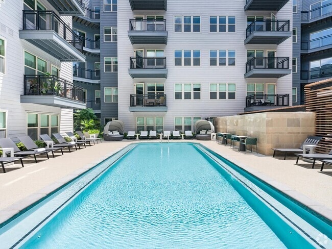 Soak up the sun or cool off in the crystal-clear pool—this courtyard oasis is your personal retreat, perfect for relaxing or entertaining. - Modera Falls Church