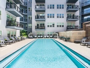Soak up the sun or cool off in the crystal-clear pool—this courtyard oasis is your personal retreat, perfect for relaxing or entertaining. - Modera Falls Church