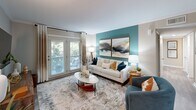 Located at 1505 Greenbrier Ridge Way in Knoxville, TN, this single-floor, 3-bedroom, 3-bathroom home offers a well-designed layout that maximizes every square foot. The living room serves as the centerpiece of the home, featuring a bold teal accent wall, crown molding, and French doors that flood the space with natural light while providing a view of the outdoors. Adjacent to the living room, the dining area features wood-look flooring, a chair rail detail, and a bright, open connection to the kitchen. The kitchen is equipped with white shaker cabinetry, granite countertops, and stainless steel appliances, with a seamless sightline into the dining space. Each of the three bedrooms carries a cohesive design aesthetic, highlighted by teal accent walls, plush carpeting, ceiling fans, and windows that bring in natural light. The primary bedroom offers a comfortable, well-proportioned retreat. The three bathrooms are finished with granite-topped vanities, white cabinetry, and wood-look tile flooring. A dedicated laundry area includes a stacked washer and dryer unit alongside built-in shelving for additional storage. The hallway connects all spaces efficiently, giving the home a practical yet polished flow throughout.
