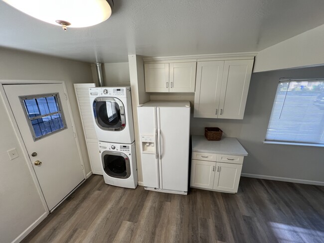 Washer and dryer in kitchen with large refrigerator - 1656 150th Ave