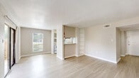 Located at 9850 S Kirkwood Rd in Houston, TX, this single-story 2-bedroom, 2-bathroom unit offers a well-organized layout with a practical mix of living spaces. The open living room features light wood-look flooring, neutral-toned walls, and a textured ceiling. Large windows and a sliding glass door flood the space with natural light and provide direct access to an outdoor patio area with greenery views. The layout connects the living room to a galley-style kitchen, which is outfitted with gray cabinetry, stone-look countertops, white appliances, and a dedicated pantry closet with built-in shelving. Both bedrooms are generously sized, with plush carpeting, ceiling fans with light fixtures, and windows offering outdoor views. The spacious primary bedroom includes direct access to its own bathroom, providing added privacy. Each bathroom is finished with wood-look tile flooring, a full tub-shower combo with tiled surround, a toilet, and a vanity with stone-look countertops. A hallway connects the main living areas to the bedrooms, and two closets provide ample storage throughout. The unit presents a clean, functional, and comfortable living environment.