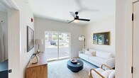 Located at 1729 Nicholasville Rd in Lexington, KY, this thoughtfully designed one-bedroom, one-bathroom residence makes excellent use of its compact footprint. The open-concept layout connects the living area and kitchen seamlessly, creating an inviting and functional space. The living room is bright and airy, highlighted by large sliding glass doors that flood the room with natural light and offer views of the outdoors. A modern ceiling fan with an integrated light fixture adds both comfort and style overhead.

The kitchen is a standout feature, outfitted with crisp white shaker-style cabinetry, granite countertops, and a full suite of stainless steel appliances including a refrigerator, range, microwave, and dishwasher. A central island with matching granite provides additional prep space and casual dining potential, while sleek pendant lighting overhead adds a contemporary touch. Light hardwood-style flooring runs throughout the main living areas, enhancing the clean, modern aesthetic.

The bedroom is a calm retreat, carpeted for comfort, and features a ceiling fan, a large window with outdoor views, and access to a dedicated closet. The bathroom continues the refined design language with white cabinetry, granite countertops, an undermount sink with matte black fixtures, and a glass-enclosed shower. The unit's neutral palette and modern finishes create a cohesive, polished atmosphere throughout.