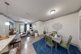 Located at 6800 Gaston Road in Katy, TX, this thoughtfully designed 2-bedroom, 3-bathroom residence offers a functional and stylish single-floor layout. The open-concept kitchen is a standout, featuring rich dark cabinetry, stainless steel appliances, granite countertops, and a breakfast bar with pendant lighting — ideal for both cooking and casual dining. Wood-look flooring flows throughout, complementing the neutral color palette.

The adjacent dining area provides a dedicated space for formal meals, complete with crown molding details, while the living room offers a comfortable, well-lit retreat. Both bedrooms are well-proportioned, with the primary bedroom showcasing a bold accent wall, ceiling fan, and ample natural light through large windows. Each bedroom is paired with dedicated closet space, including a spacious walk-in closet with wire shelving systems for organized storage.

The bathrooms are finished with granite-topped vanities, dark cabinetry, and framed mirrors, with at least one bathroom featuring a glass-enclosed walk-in shower with clean tile surround. Crown molding and consistent wood-look flooring tie the interior together cohesively, delivering a polished and practical living environment.