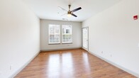 Located at 1020 Watercourse Cir in Graham, NC, this well-appointed 2-bedroom, 2-bathroom residence offers a thoughtfully designed single-level floor plan with a comfortable and functional layout. The open-concept kitchen and living area serves as the heart of the home, featuring warm hardwood-style flooring, abundant natural light, and a ceiling fan overhead. The kitchen is equipped with rich dark-cabinetry, stainless and black appliances, a central island with granite countertops, an integrated sink, and stylish pendant lighting — all flowing seamlessly into the living area, which includes an exterior door for added convenience. Both bedrooms are carpeted for comfort and include ceiling fans and windows that invite natural light. The primary bedroom offers a generous footprint, while both bedrooms provide access to closets with built-in shelving for ample storage. The two bathrooms feature hardwood-style flooring, granite-topped vanities, and clean, neutral finishes. One bathroom includes a tub-shower combination. A dedicated hallway and additional closet space contribute to the home's practical storage options. Neutral wall tones and consistent finishes throughout create a cohesive, move-in-ready atmosphere.