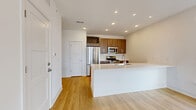 This contemporary single-story residence offers 1070 square feet of thoughtfully designed living space. The home features three bedrooms, including a primary bedroom spanning 180 square feet, and two full bathrooms. The open-concept layout combines the kitchen and living room, creating a spacious and airy atmosphere. The kitchen boasts modern wood cabinetry, sleek countertops, and stainless steel appliances, perfect for culinary enthusiasts. Both bathrooms are equipped with modern fixtures, including glass-enclosed showers and wooden vanities. Large windows throughout the home flood the interiors with natural light, complementing the warm tones of the hardwood flooring. The dedicated laundry room comes complete with a washer, dryer, and water heater. Ample storage is provided by two closets and additional shelving. Ceiling fans in the bedrooms and living areas ensure comfort year-round. The property's exterior views showcase a serene natural setting, visible through generously sized windows. Located at 631 E 91st Ave, Merrillville, IN, this home combines modern amenities with practical living spaces.