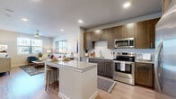 This well-designed one-bedroom, one-bathroom unit offers a thoughtfully arranged single-floor layout that maximizes its available living space. The open-concept kitchen and living area serves as the centerpiece of the unit, featuring wood-style plank flooring that flows seamlessly throughout. The kitchen is outfitted with rich dark-toned cabinetry, granite countertops, a classic white subway tile backsplash, and a full suite of stainless steel appliances including a range, microwave, dishwasher, and refrigerator. A granite-topped kitchen island provides additional prep space and doubles as a breakfast bar with seating.

The living area benefits from natural light streaming through large windows and is finished with a ceiling fan overhead. The bedroom is a comfortable, well-proportioned room with its own ceiling fan, a window with natural light, and access to a dedicated closet. The bathroom features dark cabinetry consistent with the kitchen, granite countertops, a subway tile tub-shower combination, and brushed nickel fixtures. Neutral wall tones and consistent flooring throughout create a cohesive and modern aesthetic across the entire unit.