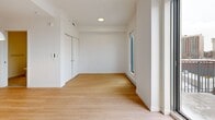 Located at 2812 Rue Ontario E in Montréal's Ville-Marie district, this thoughtfully designed single-floor unit offers a clean, contemporary aesthetic throughout. The open-concept living area is finished with light-toned hardwood flooring that enhances the sense of brightness and space. Large floor-to-ceiling sliding glass doors flood the room with natural light and provide access to an outdoor area, while also framing views of the surrounding Montreal cityscape. The crisp white walls and minimalist design keep the space feeling airy and versatile. A compact kitchen area is integrated seamlessly into the main living space, featuring modern cabinetry and built-in appliances. The bathroom is finished with elegant marble-style tile flooring and walls, and includes a glass-enclosed shower stall. A practical stacked washer and dryer unit is conveniently housed within the bathroom, adding everyday functionality. Throughout the unit, baseboard heating ensures comfort year-round. A built-in closet in the living area provides useful storage. The overall design prioritizes clean lines, neutral tones, and efficient use of space, making this a well-appointed unit suited for modern urban living in one of Montréal's vibrant neighbourhoods.