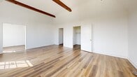 This 1050 square foot apartment in Los Angeles offers a harmonious blend of modern design and efficient space utilization. The single-floor layout encompasses one bedroom, three bathrooms, a living room, kitchen, and multiple storage areas. The primary bedroom, measuring 210 square feet, provides ample space for rest and relaxation.

Throughout the apartment, beautiful hardwood flooring adds warmth and elegance to each room. Large windows in the living areas and bedroom allow natural light to flood the space, creating a bright and airy atmosphere. The living room features exposed wooden beams, adding character to the ceiling.

The kitchen is a standout with its crisp white cabinetry, contrasting dark countertops, and stainless steel appliances. It includes a gas range and ample storage space, making it both functional and aesthetically pleasing.

One of the bathrooms showcases a unique retro design with mint green fixtures, including a bathtub and sink, complemented by beige tiled walls. This vintage touch adds charm and personality to the space.

The apartment also includes built-in storage solutions, such as a vanity area with drawers and closet space, maximizing the utility of the compact layout. The multiple hallways and closets provide additional storage options.

Located at 939 S Serrano Ave, this apartment offers a perfect blend of style, comfort, and convenience in the heart of Los Angeles.