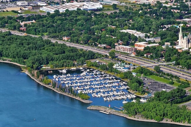 Boats docked at a marina along the Longueuil shoreline.