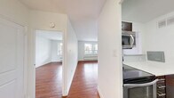 Located at 7 Elizabeth St N, Unit 603 in Mississauga, Ontario, this one-bedroom, one-bathroom unit offers a well-organized, single-floor layout with a functional and comfortable design. Warm hardwood flooring extends throughout the main living areas and bedroom, creating a cohesive and inviting atmosphere.

The combined dining and living room is generously proportioned, bathed in natural light through large windows that frame views of the surrounding Mississauga cityscape. A balcony extends the living space outdoors, providing a pleasant outdoor retreat. Baseboard heating units are positioned beneath the windows throughout.

The kitchen features stainless steel appliances, including a full-size refrigerator and built-in microwave, complemented by dark cabinetry and neutral tile flooring. It flows conveniently into the living and dining area.

The bedroom is a comfortable, well-lit room with a large window offering city views, hardwood flooring, and a mirrored closet. Two additional closets provide ample storage throughout the unit.

The bathroom is finished with warm beige rectangular wall tiles surrounding a full soaker tub and shower. The entrance hallway provides a practical transition into the main living space, completing this well-appointed unit.