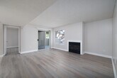 Located at 1580 Shadowridge Drive in Vista, CA, this single-floor, 2-bedroom, 2-bathroom home offers a well-organized layout designed for comfortable everyday living. The open living, dining, and kitchen area serves as the heart of the home, anchored by a classic fireplace and bathed in natural light from sliding glass doors that lead to a private patio. Light-toned wood-style flooring extends throughout the main living spaces, complementing the neutral warm-beige walls and textured ceilings.

The kitchen features rich dark wood cabinetry, tile flooring, recessed lighting, and a full suite of white appliances. A stacked washer and dryer unit is conveniently integrated within the kitchen area, providing in-unit laundry access.

Both bedrooms are well-proportioned, with the primary bedroom offering direct access to one of the two full bathrooms. Each bedroom features a closet, neutral flooring, and windows that allow for natural light. The two bathrooms are outfitted with tiled tub-shower combinations and clean, functional finishes.

Additional storage is provided through four closets distributed throughout the home. The dedicated entrance and private patio round out this practical and neatly arranged residence in the Shadowridge area of Vista.