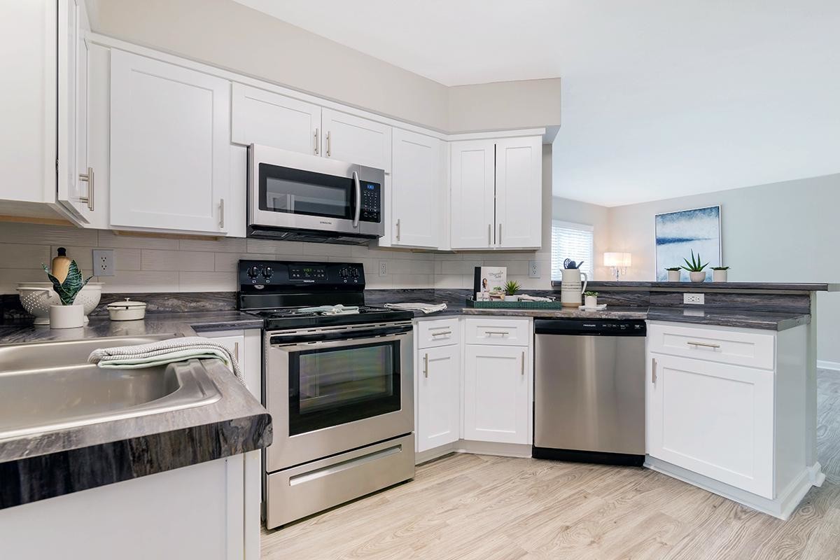 Open concept kitchens featuring wood-style flooring and breakfast bar. - Emerson Isles II