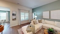 Located at 197 Braxton Boulevard in Statesboro, Georgia, this well-appointed single-story home offers 1,240 square feet of living space across 2 bedrooms, 2 bathrooms, a dedicated office, dining room, and an open-concept kitchen and living area. The living room features rich hardwood-style flooring, a sage green accent wall, and an open flow into the hallway, creating a welcoming and connected layout. The dining room is illuminated by a pendant light and a large window that allows abundant natural light, complemented by the same calming green accent walls found throughout the home. The kitchen is equipped with dark cabinetry, granite countertops, and stainless steel appliances, with a light-filled hallway leading to the entry. The primary bedroom spans 210 square feet and features dual windows, hardwood-style flooring, and a bold dark green accent wall. The second bedroom offers a similarly bright and comfortable layout. Both bathrooms include granite vanity countertops and dark wood cabinetry, with one bathroom featuring a tub-shower combination. The dedicated office includes a window with outdoor views and the same signature accent wall color. A spacious walk-in closet with wire shelving rounds out this thoughtfully designed home.