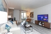 Located at 2264 Foothill Dr in Salt Lake City, UT, this well-appointed one-bedroom, one-bathroom residence offers a smart, efficient layout across a single floor. The entrance welcomes you with distinctive wood mosaic wall art and durable wood-look flooring that flows seamlessly throughout the main living areas.

The open-concept living room is bright and inviting, anchored by a tile-surround fireplace and a sliding glass door that opens to a private outdoor space, allowing natural light to fill the room. A ceiling fan adds comfort, while the generous layout accommodates both a living and dining area with ease.

The galley-style kitchen features white shaker cabinetry, grey stone countertops, and stainless steel appliances including a refrigerator, dishwasher, and range, providing a clean, functional workspace.

The spacious bedroom is carpeted for comfort, with natural light from a large window and ample room for substantial furnishings. It is complemented by a dedicated walk-in closet equipped with dual hanging rods and overhead shelving for organized storage.

The full bathroom offers a tub-shower combination, white vanity cabinetry with stone countertops, and wood-look tile flooring. A hallway connects all rooms efficiently, completing this well-organized and stylish residence.