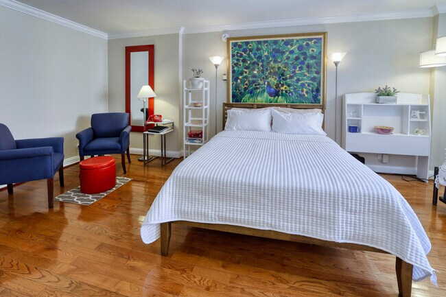 Dormitorio principal con cama y zona de estar. - 1420 N St NW