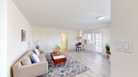 Located on the iconic Wilshire Boulevard in Los Angeles, this 1-bedroom, 2-bathroom residence offers a well-designed layout across a single floor. Light wood flooring flows throughout, complementing the bright, neutral palette that gives the home an open and airy feel.

The spacious living room is bathed in natural light from large windows and features direct access to a private balcony, providing pleasant outdoor views of the surrounding neighborhood. A dedicated workspace area within the living room adds functional versatility to the space.

The kitchen is outfitted with rich dark wood cabinetry, stainless steel appliances including a gas range, microwave, and full-size refrigerator, as well as a white breakfast bar countertop ideal for casual dining. Recessed lighting and a window enhance the kitchen's bright, clean atmosphere.

The bedroom is a comfortable retreat, featuring mirrored sliding closet doors that amplify natural light, light wood floors, and a window with outdoor views. Two full bathrooms serve the unit, one of which includes a shower-tub combination with a glass sliding door and dark wood vanity cabinetry. A hallway and dedicated closet space round out this efficiently designed residence in one of LA's most recognized corridors.