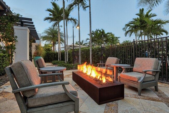 Outdoor lounges, including a firepit, allow you to enjoy the Florida weather throughout the year. - Windsor at Delray Beach