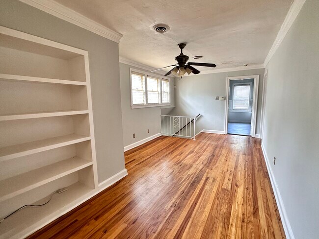 Living space with built-in bookcase - 1742 N Parkway Apartments