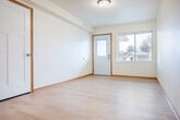 Located in Prairie du Chien, Wisconsin, this single-floor, 2-bedroom, 1-bathroom residence offers a clean and functional layout with a bright, modern aesthetic throughout. Light hardwood-style flooring runs continuously across the living areas, complemented by white walls and warm wood trim that create a cohesive and welcoming atmosphere.

The kitchen is a standout feature, outfitted with light maple cabinetry, marble-style countertops, and stainless steel appliances including a GE range, dishwasher, and refrigerator. Recessed lighting adds a polished touch to the space. A dedicated laundry area includes a stacked GE washer and dryer unit with built-in wire shelving for added convenience.

The primary bedroom is a comfortable size, featuring a ceiling fan, a large window that brings in natural light and outdoor views, and a spacious closet with built-in shelving and hanging rods. The second bedroom is equally well-appointed with its own closet storage.

The bathroom is designed with accessibility in mind, featuring grab bars, an open-clearance vanity, a large mirror, and light flooring that ties into the rest of the home. An attached garage with an automatic opener provides secure parking and additional storage. A utility room rounds out the practical offerings of this thoughtfully designed residence.