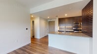 Located at 237 S Dixie Hwy in the heart of Coral Gables, Florida, this well-appointed single-floor residence showcases a clean, modern aesthetic throughout. Wood-look plank flooring runs seamlessly across the main living areas, lending warmth and continuity to the open-concept layout.

The kitchen is a standout feature, designed with rich dark-wood cabinetry extending to the ceiling for ample storage, complemented by granite countertops and a tiled backsplash. A central island with an undermount sink, stainless steel appliances — including a refrigerator, range, microwave, and dishwasher — complete the space, making it both functional and visually striking.

The living area flows naturally toward sliding glass doors that open to a private outdoor balcony, filling the space with natural light. Bedrooms are bright and airy, each with windows framing views of the surrounding Coral Gables landscape. One bedroom features a direct connection to the balcony via its own sliding door access.

The bathrooms are finished to a high standard, featuring granite-topped vanities with dark wood cabinetry, illuminated mirrors, marble-look tile flooring, and glass-enclosed shower areas. The overall ambiance throughout is contemporary and refined, with a neutral palette that highlights the quality of materials and finishes present in every room.