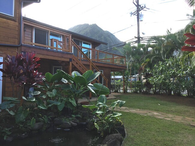 the house sits on a corner lot, landscaped and fenced yard, with a pond - 45-673 Anoi Rd