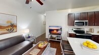 Located at 510 W 26th St in Austin, TX, this single-floor unit offers a well-organized layout that makes smart use of its compact footprint. The open-concept design integrates the living, dining, and sleeping areas into one cohesive space, promoting a sense of openness. Warm hardwood-style flooring runs throughout, complemented by clean white walls and a ceiling fan that enhances air circulation and comfort.

The kitchen is a standout feature, equipped with rich dark-brown cabinetry extending to the upper walls for generous storage, white countertops, a subway tile backsplash, and a full suite of stainless steel appliances including a refrigerator, dishwasher, electric range, and microwave. A kitchen island provides additional counter space and casual seating. A window in the kitchen brings in natural light, adding to the room's functionality.

The bathroom is clean and well-appointed, featuring a full tub-shower combination with white tile surround, dark wood cabinetry for storage, hardwood-style flooring, and neutral tones that create a calm, practical atmosphere.

The living area benefits from ceiling height that lends an airy feel, with room for a seating arrangement, a dedicated workspace, and a sleeping area. Overall, the unit offers a practical and comfortable living environment in a central Austin location.