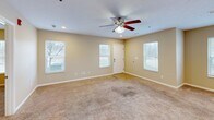 This well-appointed 2-bedroom, 2-bathroom single-story home in Mount Vernon, Illinois offers a practical and comfortable layout across a generously sized floor plan. The open-concept living area is anchored by plush carpeting and a ceiling fan with light fixture, creating a welcoming atmosphere. Multiple windows flood the space with natural light and provide views of the surrounding neighborhood. The kitchen is a functional highlight, featuring rich medium-toned wood cabinetry, stainless steel appliances including a refrigerator with ice maker, electric range, microwave, and dishwasher, all set atop tile flooring with ample counter space. The primary bedroom offers a comfortable retreat with carpeted floors, a ceiling fan, and closet access. The second bedroom is equally well-sized with soft carpeting and neutral walls. Both bathrooms are finished with tile flooring, warm cabinetry, and standard fixtures. A dedicated laundry room includes washer/dryer hookups and a wall-mounted drying rack. The attached garage is spacious, clean, and equipped with an automatic opener. Five closets throughout provide excellent storage. The home's neutral color palette and consistent finishes create a cohesive, move-in-ready environment.