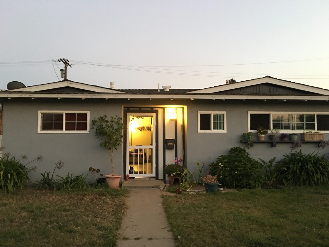 This is the front of the home with a warm and inviting porch and beautiful, vinyl screen door- perfect for ventilation during those warm summer nights - 400 East Airport Avenue