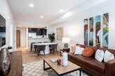 Located on Lincoln Ave in Cypress, CA, this single-floor residence offers a thoughtfully designed open-concept layout with modern finishes and a clean, contemporary aesthetic. Light wood flooring flows throughout the main living areas, complemented by recessed lighting and neutral wall tones that create a bright, welcoming atmosphere.

The kitchen is a functional highlight, showcasing rich dark espresso cabinetry, white quartz countertops, and a classic white subway tile backsplash. Stainless steel appliances — including a side-by-side refrigerator, electric range, built-in microwave, and dishwasher — complete the space. A pass-through counter connects the kitchen to the living area, enhancing the open feel.

The living room is generously proportioned, featuring recessed lighting and a large window that allows ample natural light to fill the room. The bedroom offers a serene retreat, with sliding glass doors that open to an outdoor view and provide additional natural light. Vertical blinds offer privacy while maintaining the airy character of the room.

The bathroom is cleanly finished with a full tub-and-shower combination, light wood flooring, a dark vanity with white countertop, and a well-placed mirror. The entryway features a modern wood-panel door and opens directly adjacent to the kitchen for convenient access throughout the home.