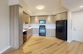 Located at 10455 Old Cutler Rd in Cutler Bay, FL, this well-appointed one-bedroom, one-bathroom residence offers a thoughtfully designed single-floor layout. Light wood-look flooring flows throughout the unit, creating a warm and cohesive aesthetic.

The open-concept kitchen and living area serves as the heart of the home. The kitchen is equipped with modern light wood cabinetry extending to the ceiling for maximum storage, white quartz-style countertops, a subway tile backsplash, and a full suite of black appliances including a range, built-in microwave, dishwasher, and refrigerator.

The bedroom is a comfortable, well-lit retreat featuring a ceiling fan, a window with outdoor views, and neutral warm-toned walls. Two closets provide generous storage, including a walk-in closet outfitted with wire shelving on multiple walls. The bathroom is finished with large-format neutral tile surrounding a full soaking tub and shower, a wood-accented vanity with a white countertop, and recessed lighting.

Additional conveniences include a dedicated laundry area and a utility room. The unit's clean, contemporary finishes and functional floor plan make it a practical and attractive residence in the Cutler Bay community.
