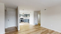 Located at 4653 Refugee Rd. in Columbus, Ohio, this thoughtfully updated 2-bedroom, 1-bathroom home offers a clean, modern aesthetic throughout its single floor. Light-toned hardwood flooring runs through the main living areas, lending a bright and cohesive feel to the open-concept kitchen and living room. The kitchen is a standout feature, showcasing slate-blue shaker-style cabinetry, light stone countertops, a classic subway tile backsplash, and a full suite of stainless steel appliances including a refrigerator, range, and dishwasher. A pendant light adds a finishing touch above the workspace. The living area is airy and well-lit, with a large window drawing in natural light, and a distinctive vertical shiplap accent wall that adds architectural character. The primary bedroom features its own shiplap accent wall and a dedicated closet, while both bedrooms are finished with plush carpet for added comfort. The full bathroom includes a tub-shower combination with clean white finishes and hardwood-style flooring. With four closets distributed throughout, storage is plentiful. The hallway connects each space efficiently, completing a practical and polished floor plan well-suited for everyday living.