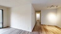 Located on Massachusetts Avenue NW in the heart of Washington, DC, this two-bedroom, two-bathroom residence offers a practical and well-organized layout across a comfortable single floor. Hardwood-style flooring flows consistently throughout the space, lending a clean, cohesive aesthetic to every room.

The living room is a standout feature, benefiting from floor-to-ceiling windows that flood the space with natural light and frame views of the surrounding cityscape. A sliding glass door provides direct access to an outdoor balcony, enhancing the open feel of the room.

The kitchen is outfitted with warm oak cabinetry, granite-style countertops, a gas range, dishwasher, and a sink with ample counter space — providing a fully functional cooking environment. The cabinetry offers generous storage throughout.

The spacious primary bedroom comfortably accommodates large furnishings, and features a closet with sliding panel doors. The second bedroom is well-proportioned with its own closet access. Both bedrooms are finished with the same hardwood-style flooring found throughout the residence.

Both bathrooms are identically appointed with white tile surround tub-shower combinations, warm wood vanity cabinetry, granite-style countertops, and large mirrors. A central hallway connects all rooms efficiently, and four total closets provide exceptional storage capacity throughout the home.
