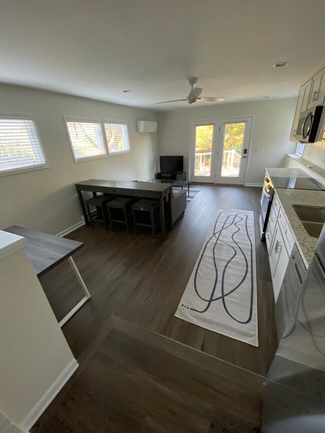 Sitting/dining area behind sofa. Ceiling fan. Mini Split Heat/AC - 802 Gracelyn Ct