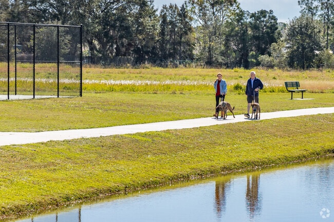 Trinity dog park sits beside a lake and features paths for walking dogs.
