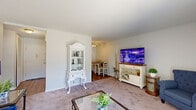 Located at 1123 N Edmondson Ave in Warren Park, Indiana, this one-bedroom, one-bathroom unit offers a well-organized single-floor layout with a thoughtful mix of living spaces. The carpeted living room is bright and inviting, featuring a large sliding glass door with vertical blinds that floods the space with natural light and provides outdoor views. A ceiling fan and wall-mounted air conditioning unit add functional comfort to the room. The living area flows naturally into a dedicated dining room, separated by a ceiling fan overhead, creating a clear distinction between the two spaces. The galley-style kitchen is efficiently designed with white cabinetry, granite-look countertops, hardwood-style flooring, and white appliances including a refrigerator and range. The bedroom is a comfortable retreat, highlighted by a ceiling fan, a large window with outdoor views, and an expansive wall of louvered bi-fold closet doors offering generous storage. The unit includes four closets in total, ensuring abundant storage throughout. The bathroom features a full tiled tub-shower combination with chrome fixtures. A connecting hallway links the main living areas seamlessly, completing this compact yet functional residential unit.